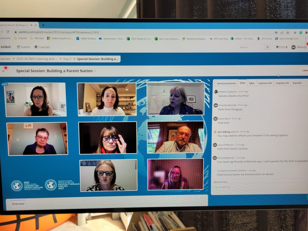 A computer screen displaying a virtual meeting with eight participants, including children and grownups, each in separate video boxes, engaged in a discussion.